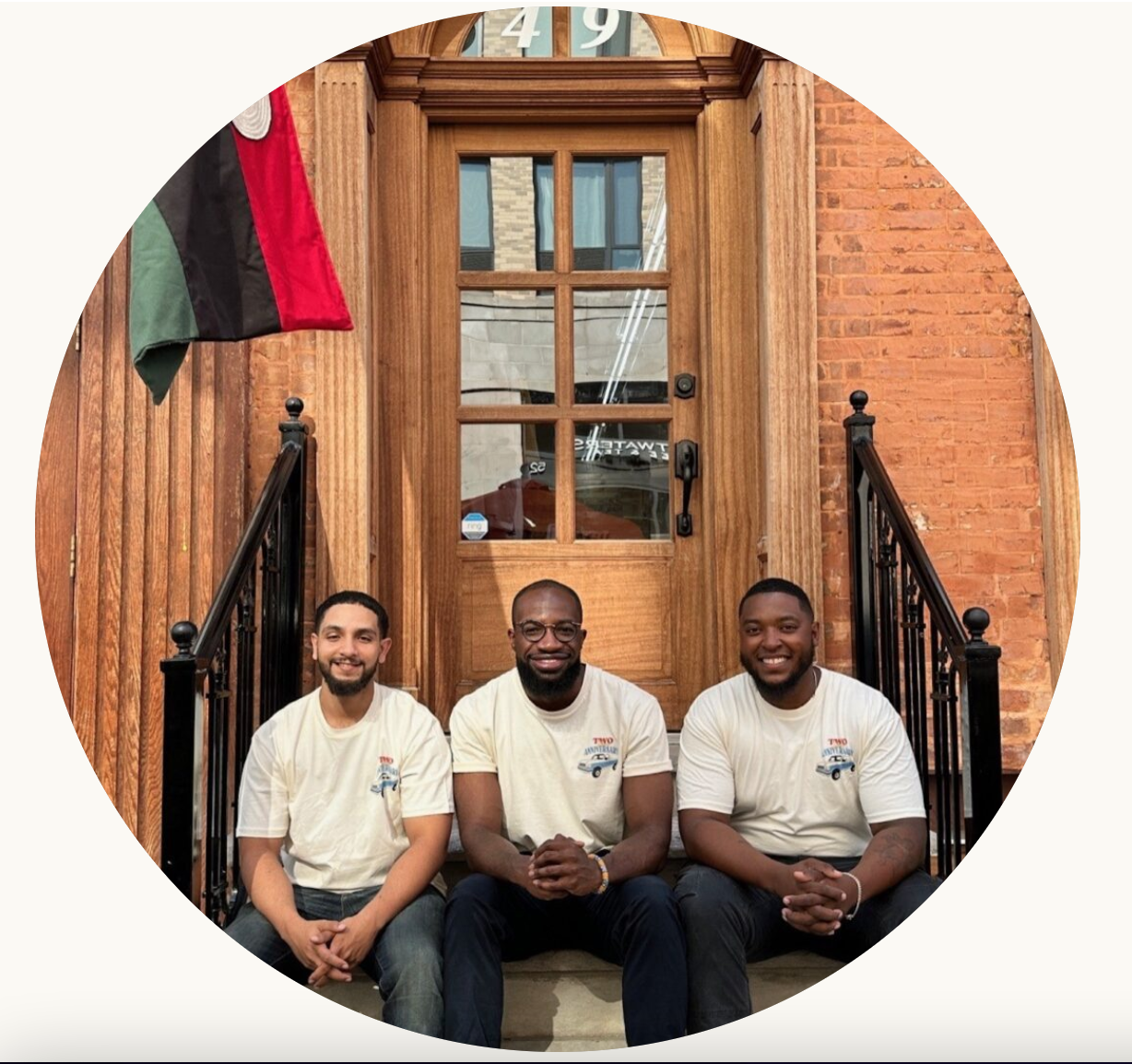 Image of three men on a front stoop.