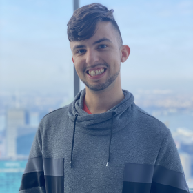 photo of Andrew Moreira in a gray pullover smiling forward