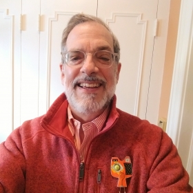 Photo of Ulysses in a red pullover smiling forward