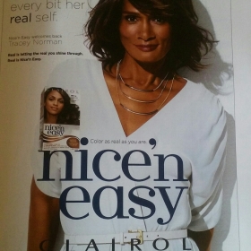 Tracey Africa in a Nice n Easy ad. She has shoulder length hair and is wearing a white shirt.