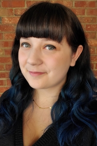 Photo of Isabella Sangaline in front of a brick background